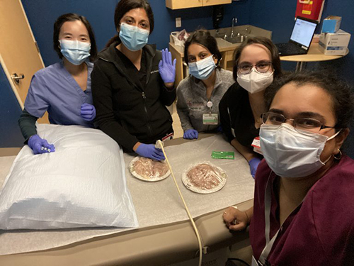 people in hospital scrubs and masks
