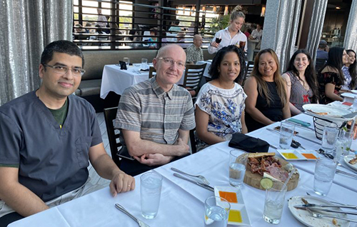 people at a table posing for a photo