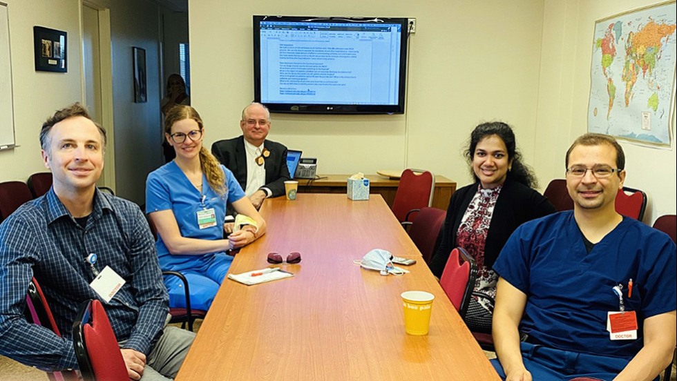 five people sitting at a table